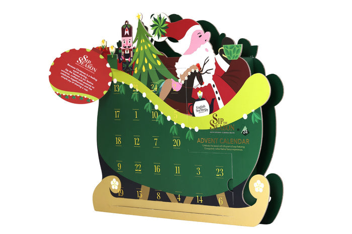A festive pop-up Christmas advent calendar from Sip the Season, featuring a green calendar face, a gold sleigh base, a red Santa hat, and a cartoon pig dressed as Santa Claus with a green sleigh and tree backdrop, isolated on a white background.